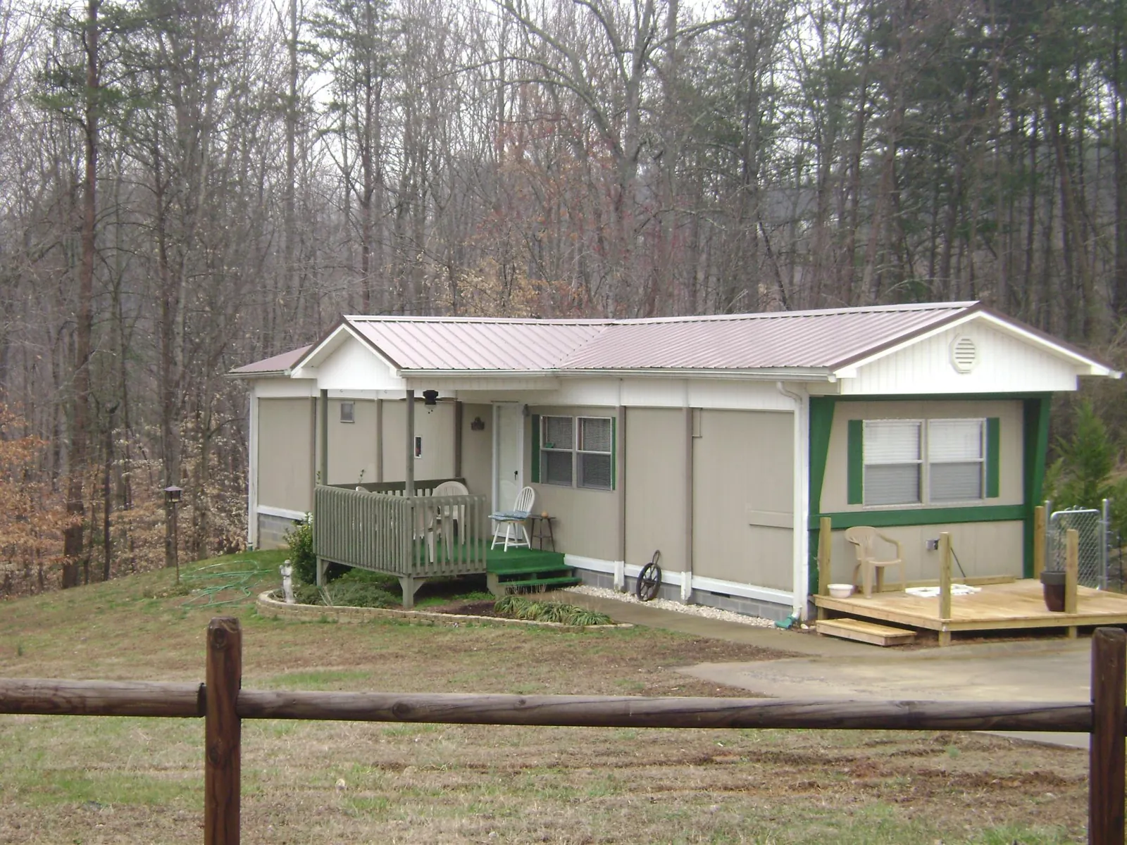 Mauve metal roof on a manufactured home with a new front deck in Albion